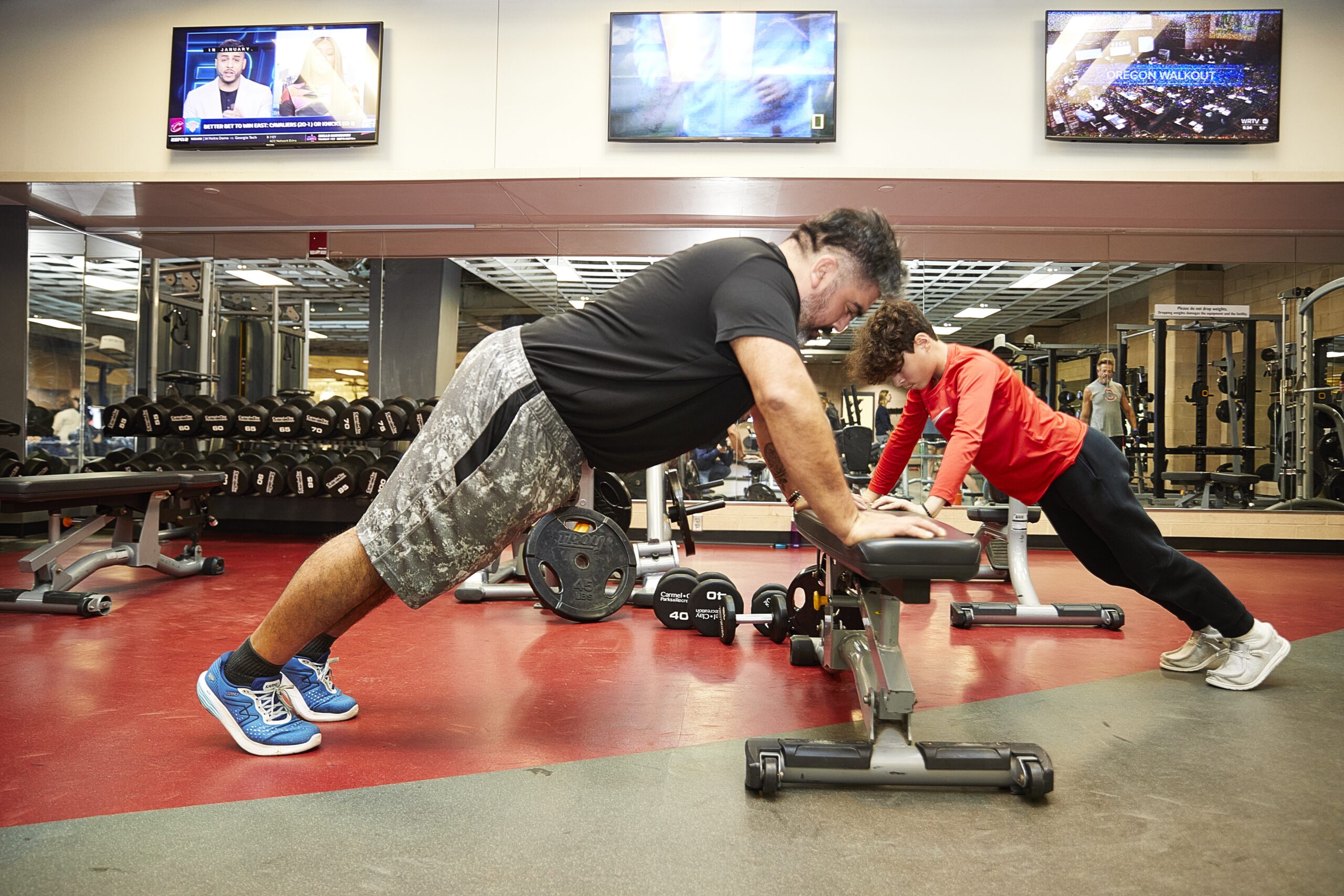 Liendo family working out in the weight area at the Monon Community Center.