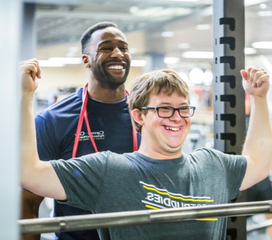 A client is working with a personal trainer at the MCC fitness center.